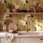 Japanese crane wallpaper with white, black and red cranes in flight on an antique-gold textured ground