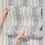 Blue wallpaper with indigo botanical stripework, pinstripes and dotted borders on warm cream parchment