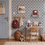 Cream colored wallpaper with denim blue geometric totem stripe repeat on a linen texture ground