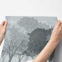 Light gray wallpaper mural with misty forest trees, falling leaves and birds