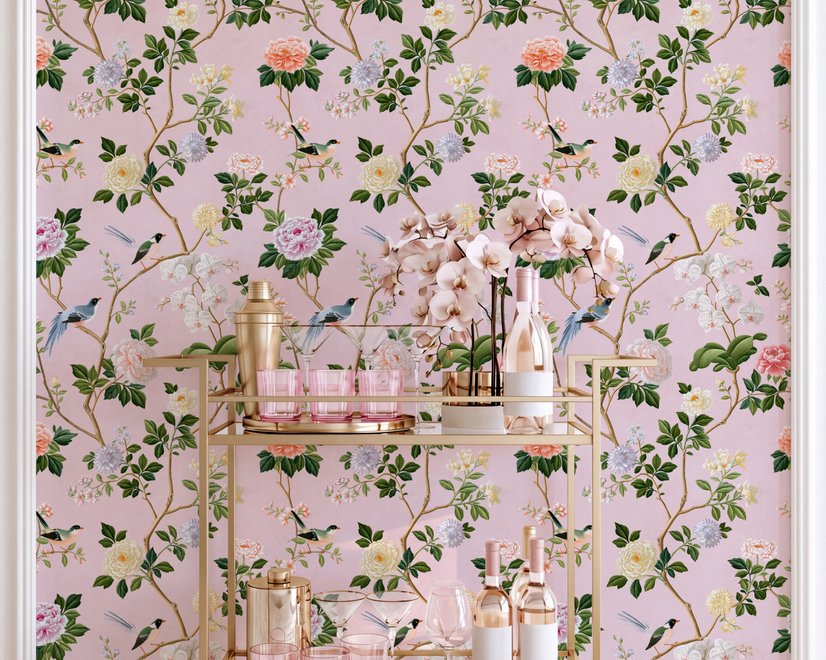 Cute pink wallpaper with birds, tan branches, green leaves and ivory, coral and lilac flowers.