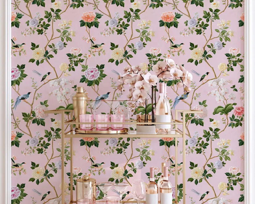 Cute pink wallpaper with birds, tan branches, green leaves and ivory, coral and lilac flowers.