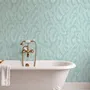 Aqua fern wallpaper with overlapping icy blue palm fronds on a pale aqua ground