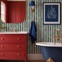 Green striped minimalist wallpaper with vertical deep forest green bands on a soft warm ivory ground.