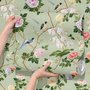 Celadon-sage chinoiserie wallpaper with blue-grey birds, tan branches, pink peonies and white orchids