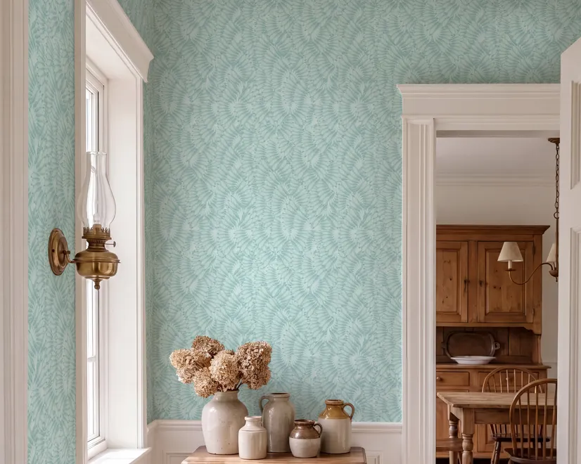 Aqua fern wallpaper with overlapping icy blue palm fronds on a pale aqua ground