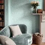 Aqua fern wallpaper with overlapping icy blue palm fronds on a pale aqua ground