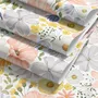 Spring floral wallpaper with pastel watercolour flowers and sage leaves on a clean white ground