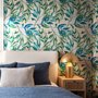 Dark olive green wallpaper with teal and cobalt watercolour lance leaves on a white ground