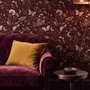 Pink butterflies wallpaper on a claret ground with cream flowers, moons, stars and spotted mushrooms.