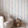 Blue and light blue wallpaper with hand-painted vertical watercolour stripes on a clean white ground