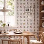 Bar wallpaper with cream tile grid, dusty rose arches, illustrated wine bottles, fruit and café still lifes