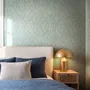 Aqua fern wallpaper with overlapping icy blue palm fronds on a pale aqua ground