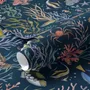Aquarium fish tank wallpaper repeat with tropical fish, coral, seaweed, shells and bubbles on deep navy blue