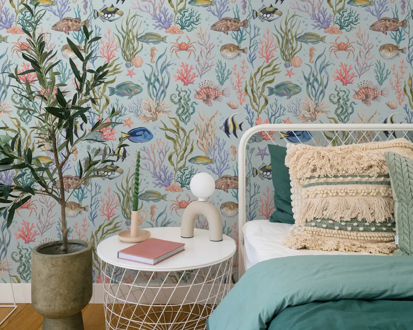 Modern coastal wallpaper with watercolour tropical fish, coral, seaweed, shells and bubbles on light aqua-blue