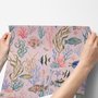 Cute pink seashell wallpaper with watercolour reef fish, coral, seaweed, starfish and shells on blush pink