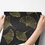 Black wallpaper with antique metallic gold ginkgo leaves on a mottled charcoal ground