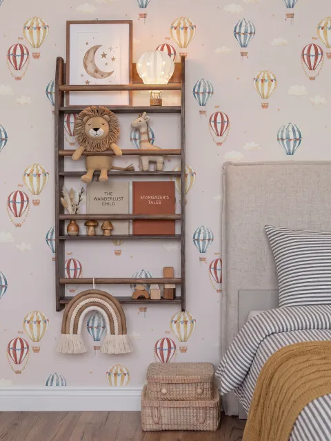 Hot air balloon nursery room wallpaper with watercolour balloons, clouds and stars on a soft blush-pink ground