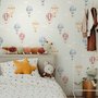 Watercolor blue wallpaper with hot air balloons, cream clouds and peach stars on pale sage green