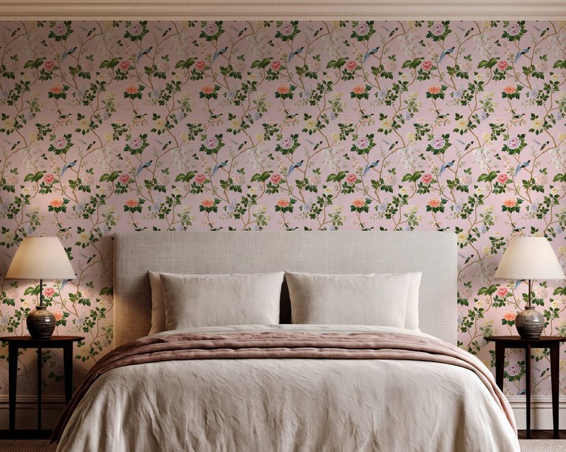 Cute pink wallpaper with birds, tan branches, green leaves and ivory, coral and lilac flowers.