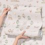 Children's playroom wallpaper with pastel Ferris wheel, carousel horses, tents and balloons on blush pink