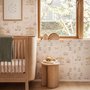 Children's playroom wallpaper with pastel Ferris wheel, carousel horses, tents and balloons on blush pink