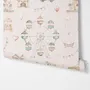 Children's playroom wallpaper with pastel Ferris wheel, carousel horses, tents and balloons on blush pink