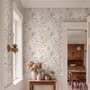 Watercolour wildflower wallpaper with pastel flowers and sage leaves on a white ground