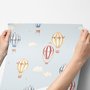 Hot air balloon wallpaper with watercolor balloons, ivory clouds and peach gold stars on pale powder blue