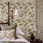 Chinoiserie wallpaper with blue-grey birds, pink peonies, white orchids and green branches on ivory-cream ground