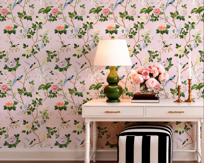 Cute pink wallpaper with birds, tan branches, green leaves and ivory, coral and lilac flowers.