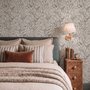Black outline botanical wallpaper with charcoal wildflowers and grasses on a warm ivory cream ground