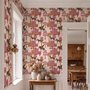 Tropical foliage wallpaper with black panthers, pink palace facades and ochre palms on pale peach