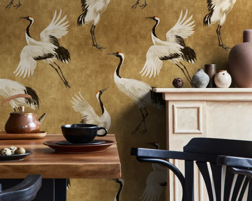 Japanese crane wallpaper with white, black and red cranes in flight on an antique-gold textured ground