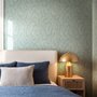 Aqua fern wallpaper with overlapping icy blue palm fronds on a pale aqua ground