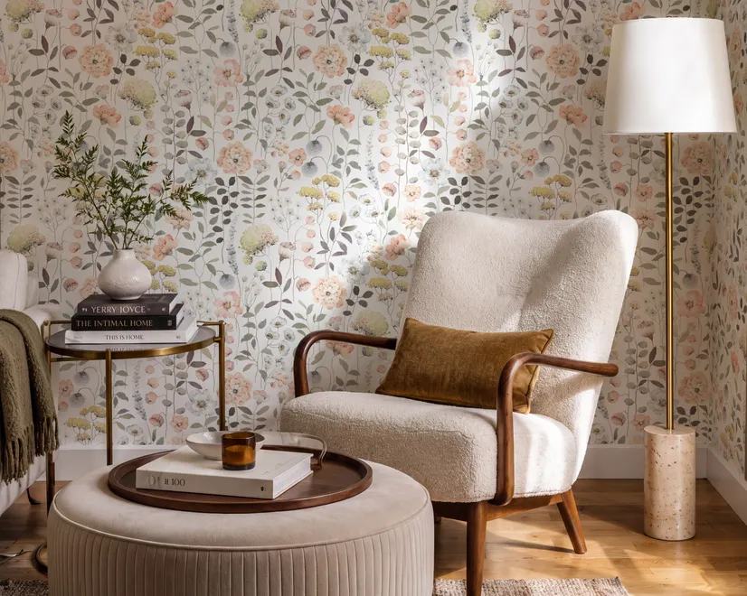 Watercolour wildflower wallpaper with pastel flowers and sage leaves on a white ground