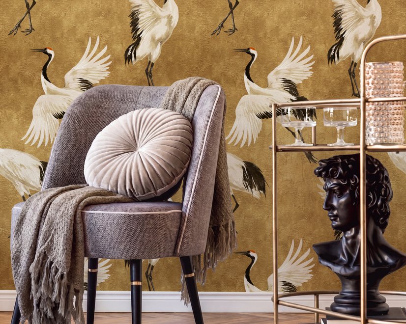 Japanese crane wallpaper with white, black and red cranes in flight on an antique-gold textured ground