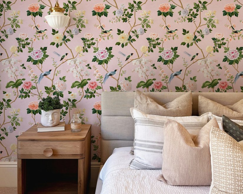 Cute pink wallpaper with birds, tan branches, green leaves and ivory, coral and lilac flowers.