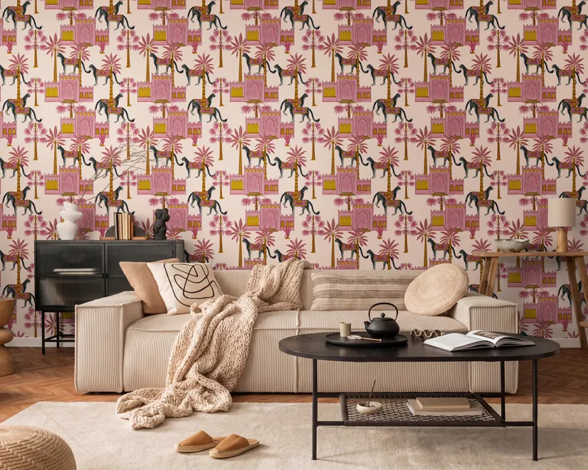 Tropical foliage wallpaper with black panthers, pink palace facades and ochre palms on pale peach