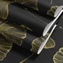 Black wallpaper with antique metallic gold ginkgo leaves on a mottled charcoal ground