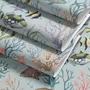Modern coastal wallpaper with watercolour tropical fish, coral, seaweed, shells and bubbles on light aqua-blue