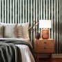 Green striped minimalist wallpaper with vertical deep forest green bands on a soft warm ivory ground.