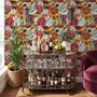 Floral and fish wallpaper with coral blooms, teal fish and black white flowers on metallic mustard-gold ground