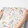 Watercolour wildflower wallpaper with pastel flowers and sage leaves on a white ground