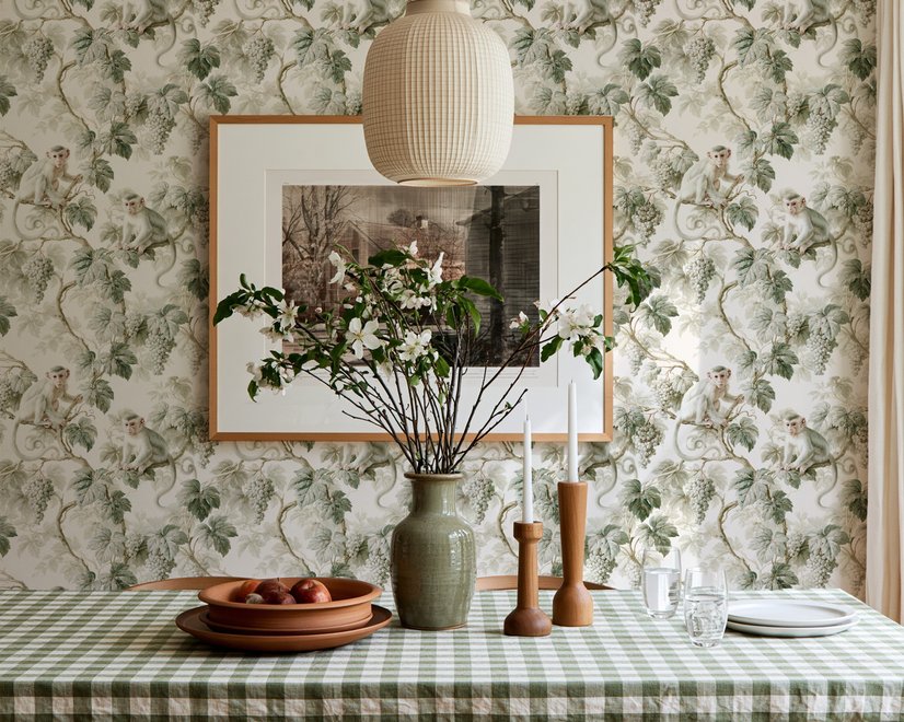 Vintage nature wallpaper with pale monkeys, sage grape leaves, white grape clusters and taupe vines on ivory.