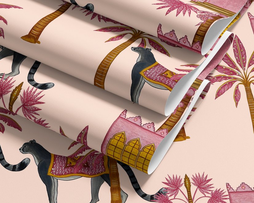 Tropical foliage wallpaper with black panthers, pink palace facades and ochre palms on pale peach