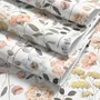 Watercolour wildflower wallpaper with pastel flowers and sage leaves on a white ground