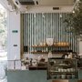 Green striped minimalist wallpaper with vertical deep forest green bands on a soft warm ivory ground.