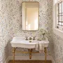 Watercolour wildflower wallpaper with pastel flowers and sage leaves on a white ground
