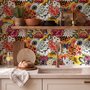 Floral and fish wallpaper with coral blooms, teal fish and black white flowers on metallic mustard-gold ground
